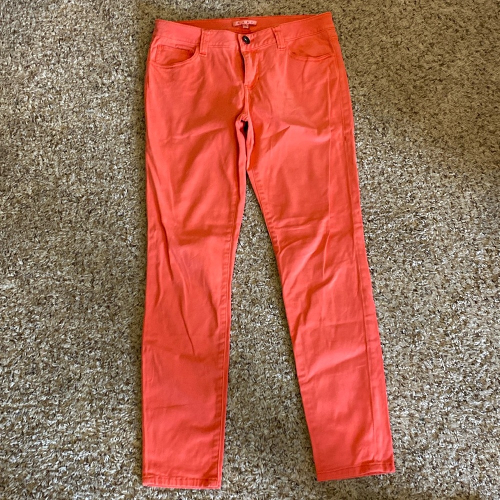 Women's Cabi coral colored jeans.